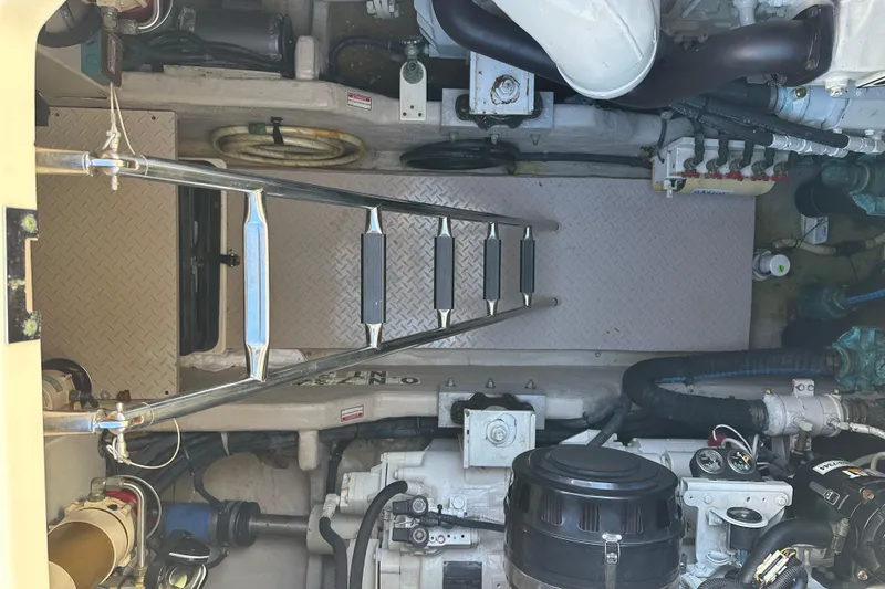 Slide: The Image of Engine room of 2001 Sea Ray 540 Sundancer with ladder and mechanical components. - 49