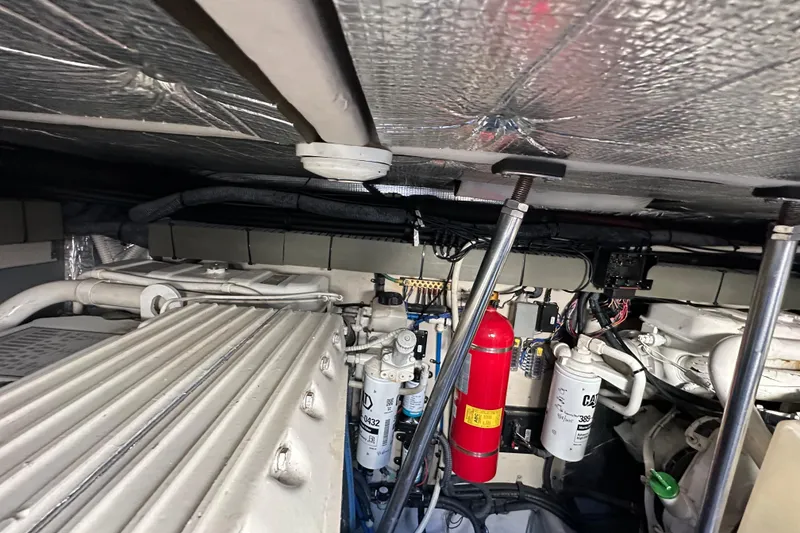 Slide: The Image of Engine room of a 2001 Sea Ray 540 Sundancer with visible components and fire extinguisher. - 57