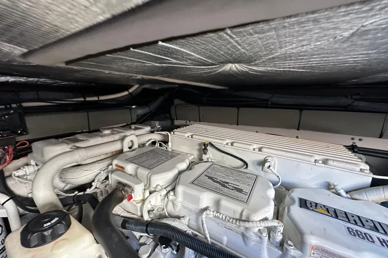 Slide: The Image of Engine room of a 2001 Sea Ray 540 Sundancer yacht, featuring Caterpillar components. - 59