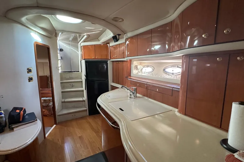 Slide: The Image of Luxurious 2001 Sea Ray 540 Sundancer yacht interior with modern kitchen and wooden cabinetry. - 6