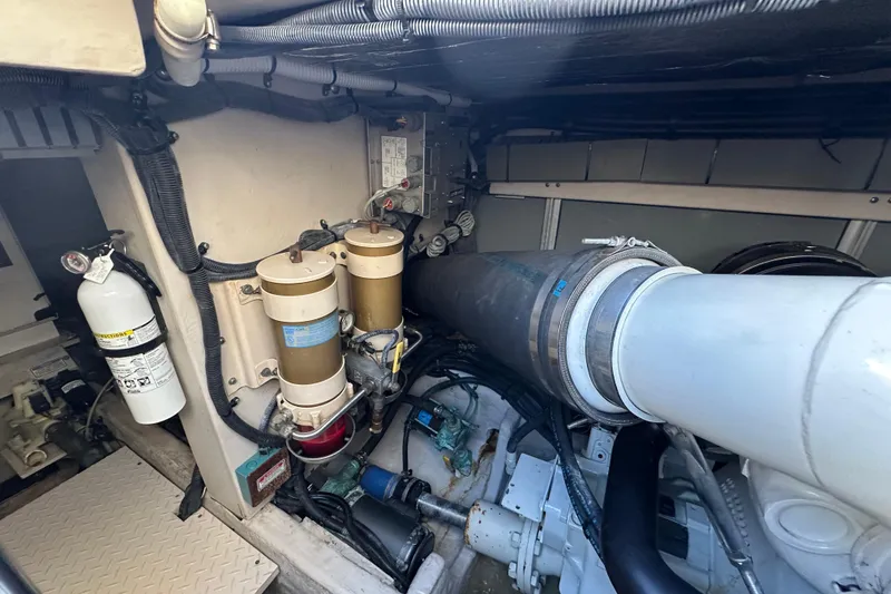 Slide: The Image of Engine room of 2001 Sea Ray 540 Sundancer with visible components and fire extinguisher. - 63