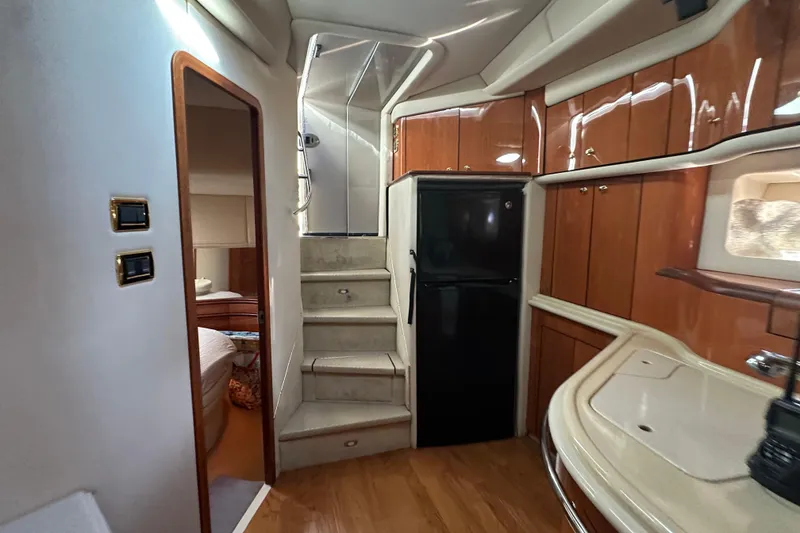 Slide: The Image of Interior of 2001 Sea Ray 540 Sundancer yacht with wooden cabinetry and stairs. - 7
