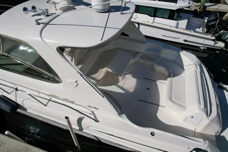 Slide: The Image of 2001 Sea Ray 540 Sundancer yacht with spacious white deck and seating area. - 74