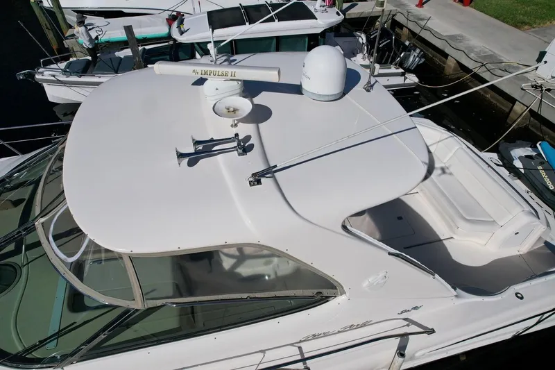 Slide: The Image of 2001 Sea Ray 540 Sundancer yacht docked, aerial view of sleek design and spacious deck. - 75