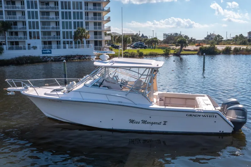 The Image of 2005 Grady-White Express 330 boat with Yamaha engines near waterfront apartments. - 0