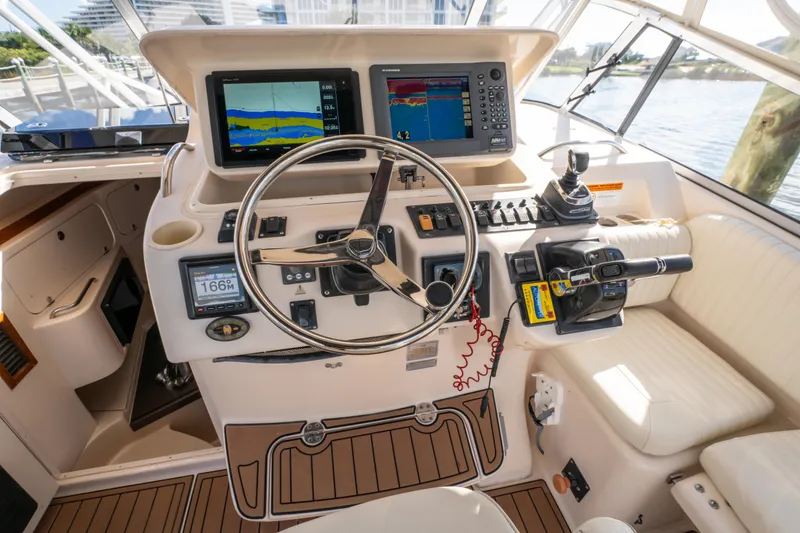 Slide: The Image of 2005 Grady-White Express 330 helm with navigation screens and controls. - 15