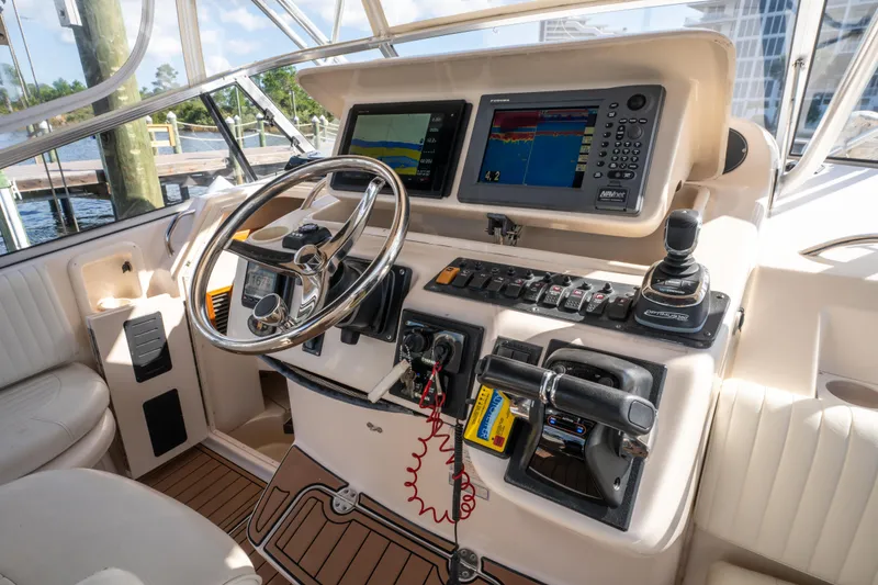 Slide: The Image of Helm of 2005 Grady-White Express 330 with advanced navigation and control systems. - 16