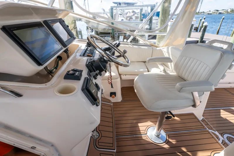 Slide: The Image of 2005 Grady-White Express 330 helm with modern controls and comfortable seating. - 19