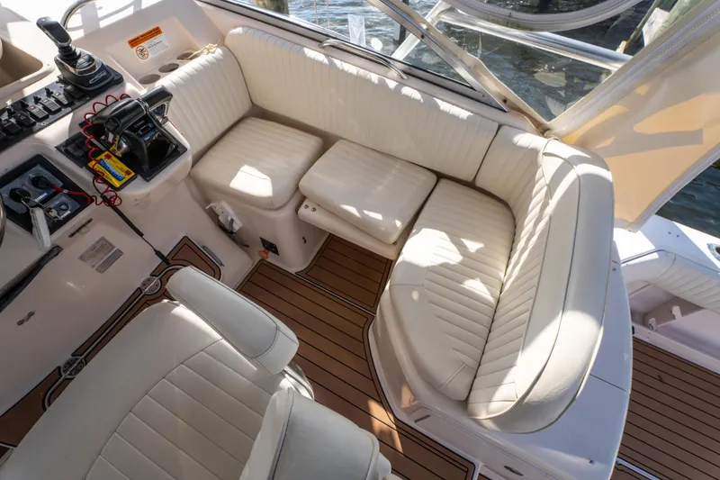 Slide: The Image of 2005 Grady-White Express 330 boat interior with white seating and control panel. - 21
