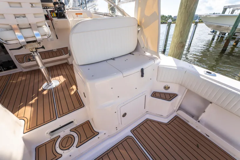 Slide: The Image of 2005 Grady-White Express 330 boat interior with teak flooring and white seating. - 24