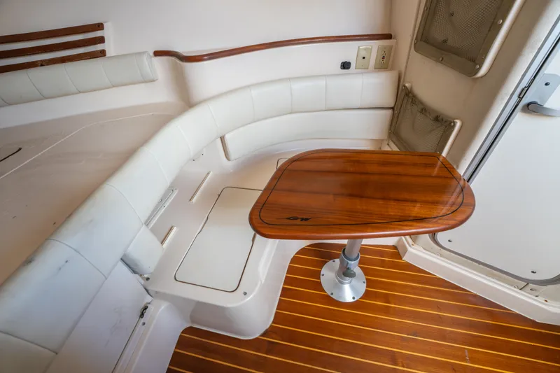Slide: The Image of 2005 Grady-White Express 330 interior with wooden table and white seating. - 29