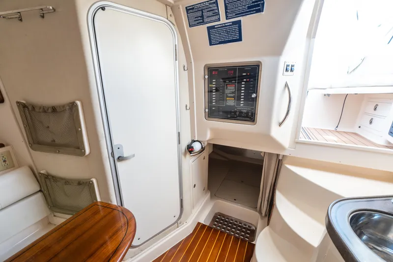 Slide: The Image of 2005 Grady-White Express 330 cabin interior with control panel and wooden flooring. - 30