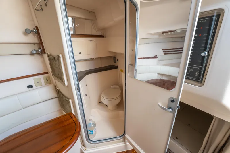 Slide: The Image of 2005 Grady-White Express 330 boat interior with bathroom and control panel. - 31