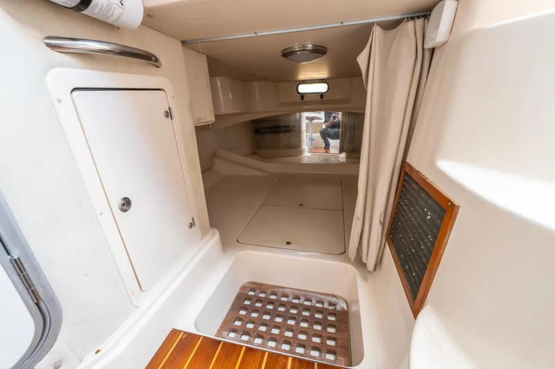 Slide: The Image of 2005 Grady-White Express 330 cabin interior with storage and wooden flooring. - 32