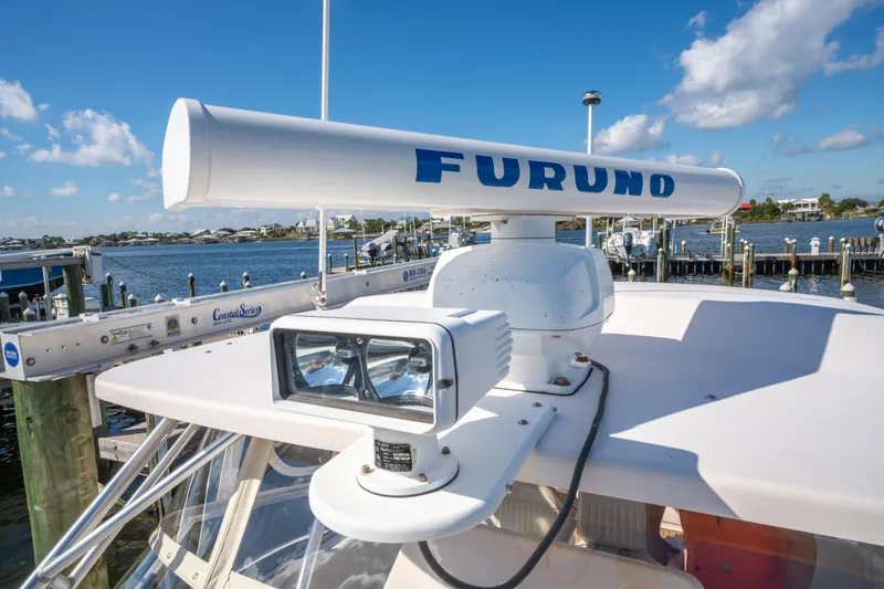 Slide: The Image of 2005 Grady-White Express 330 with Furuno radar, docked by a scenic waterfront. - 37