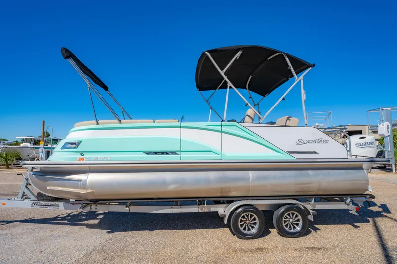 Slide: The Image of 2021 Silver Wave 2410 SW5 JS pontoon boat on trailer, featuring a sleek design. - 10