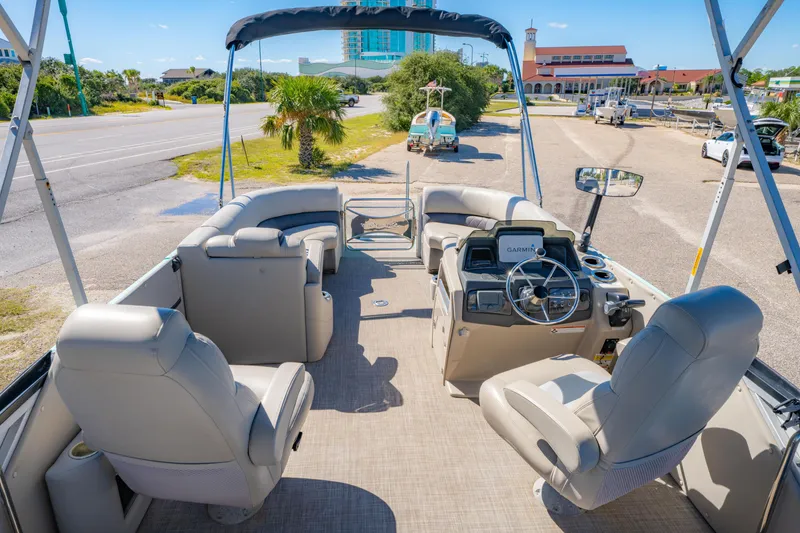 Slide: The Image of 2021 Silver Wave 2410 SW5 JS pontoon boat interior with seating and steering console. - 16