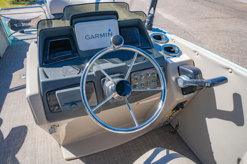 Slide: The Image of 2021 Silver Wave 2410 SW5 JS boat dashboard with Garmin navigation system and steering wheel. - 17