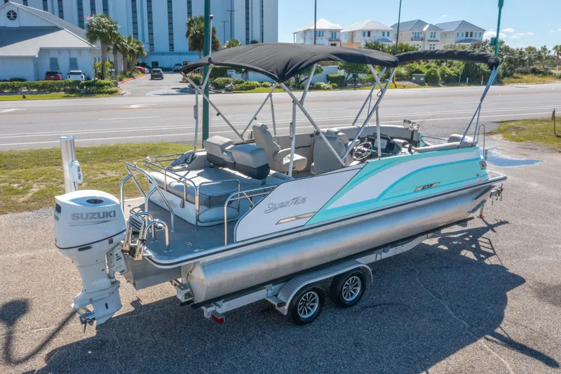 Slide: The Image of 2021 Silver Wave 2410 SW5 JS pontoon boat with Suzuki outboard motor on trailer. - 3