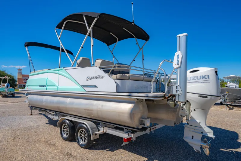 Slide: The Image of 2021 Silver Wave 2410 SW5 JS pontoon boat with Suzuki engine on trailer. - 7