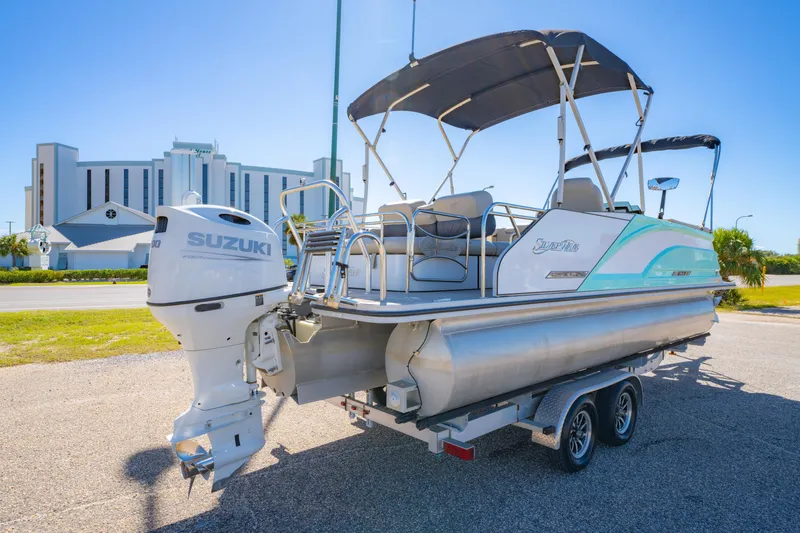 Slide: The Image of 2021 Silver Wave 2410 SW5 JS pontoon boat with Suzuki outboard motor on trailer. - 8