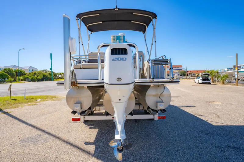 Slide: The Image of 2021 Silver Wave 2410 SW5 JS pontoon boat with 200 HP engine, parked on trailer. - 9