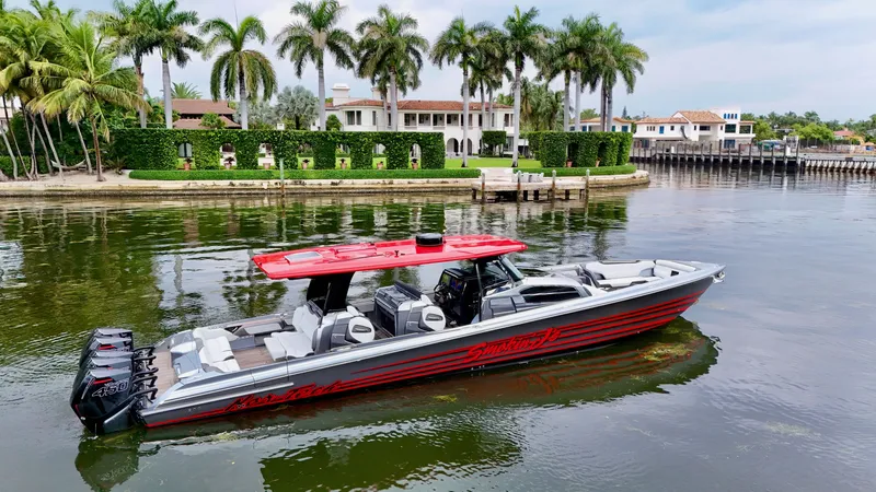 Slide: The Image of 2022 Nor-Tech 50 Sport boat on water, palm trees and luxury homes in background. - 11