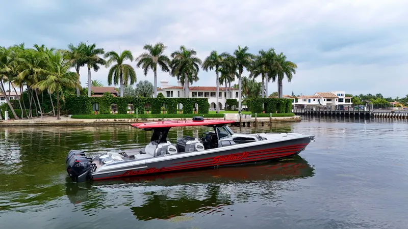 Slide: The Image of 2022 Nor-Tech 50 Sport boat cruising near luxury waterfront homes and palm trees. - 13