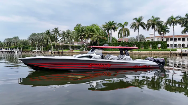 Slide: The Image of 2022 Nor-Tech 50 Sport boat on calm water, surrounded by palm trees and luxury homes. - 15