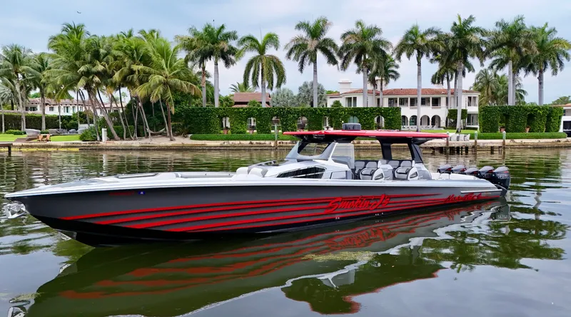 Slide: The Image of 2022 Nor-Tech 50 Sport boat on water, sleek design, palm trees in background. - 16