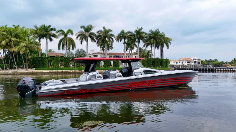 Slide: The Image of 2022 Nor-Tech 50 Sport boat on water, palm trees and luxury homes in background. - 17