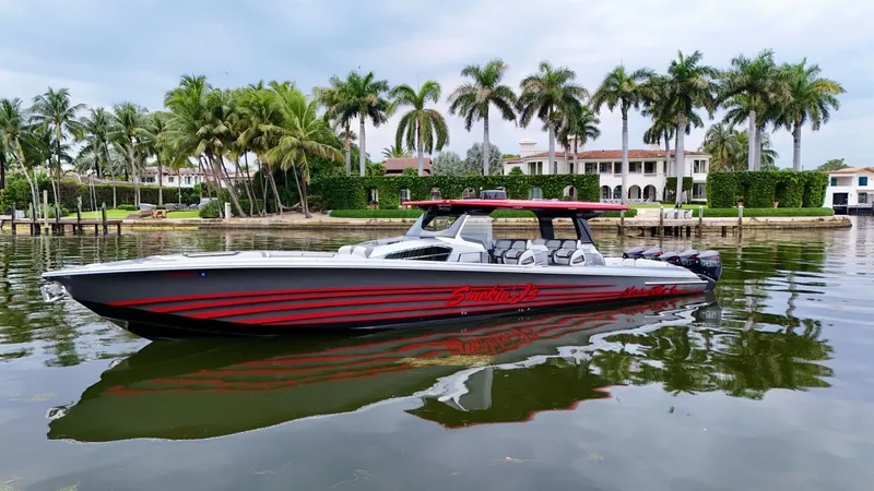 Slide: The Image of 2022 Nor-Tech 50 Sport boat on calm water, surrounded by palm trees and luxury homes. - 19