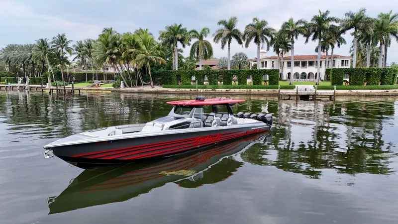 Slide: The Image of 2022 Nor-Tech 50 Sport boat on calm water, surrounded by palm trees and luxury estate. - 24