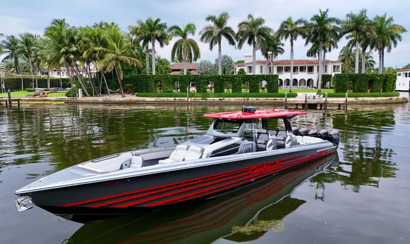 Slide: The Image of 2022 Nor-Tech 50 Sport boat on calm water, luxury waterfront estate in background. - 25