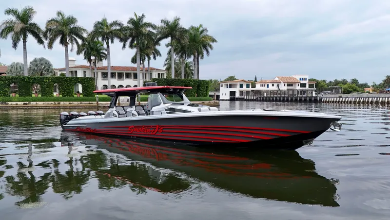 Slide: The Image of 2022 Nor-Tech 50 Sport boat on calm water, with palm trees and luxury homes in the background. - 29