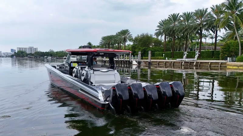 Slide: The Image of 2022 Nor-Tech 50 Sport boat with multiple engines on a calm waterway. - 30