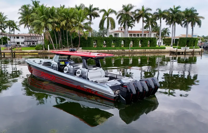 Slide: The Image of 2022 Nor-Tech 50 Sport boat on calm water with palm trees in the background. - 36