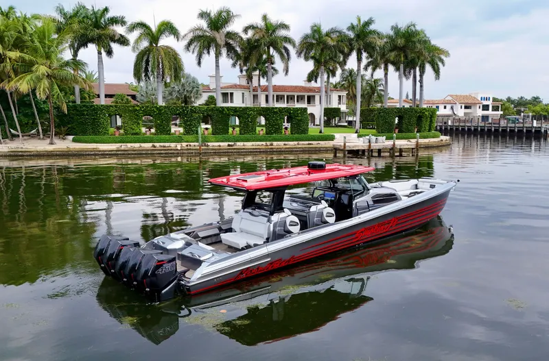 Slide: The Image of 2022 Nor-Tech 50 Sport boat on calm water, with luxury waterfront homes and palm trees in the background. - 4