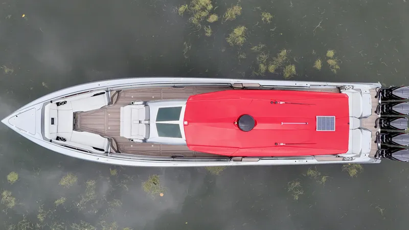 Slide: The Image of Aerial view of 2022 Nor-Tech 50 Sport boat with red cover on water. - 41