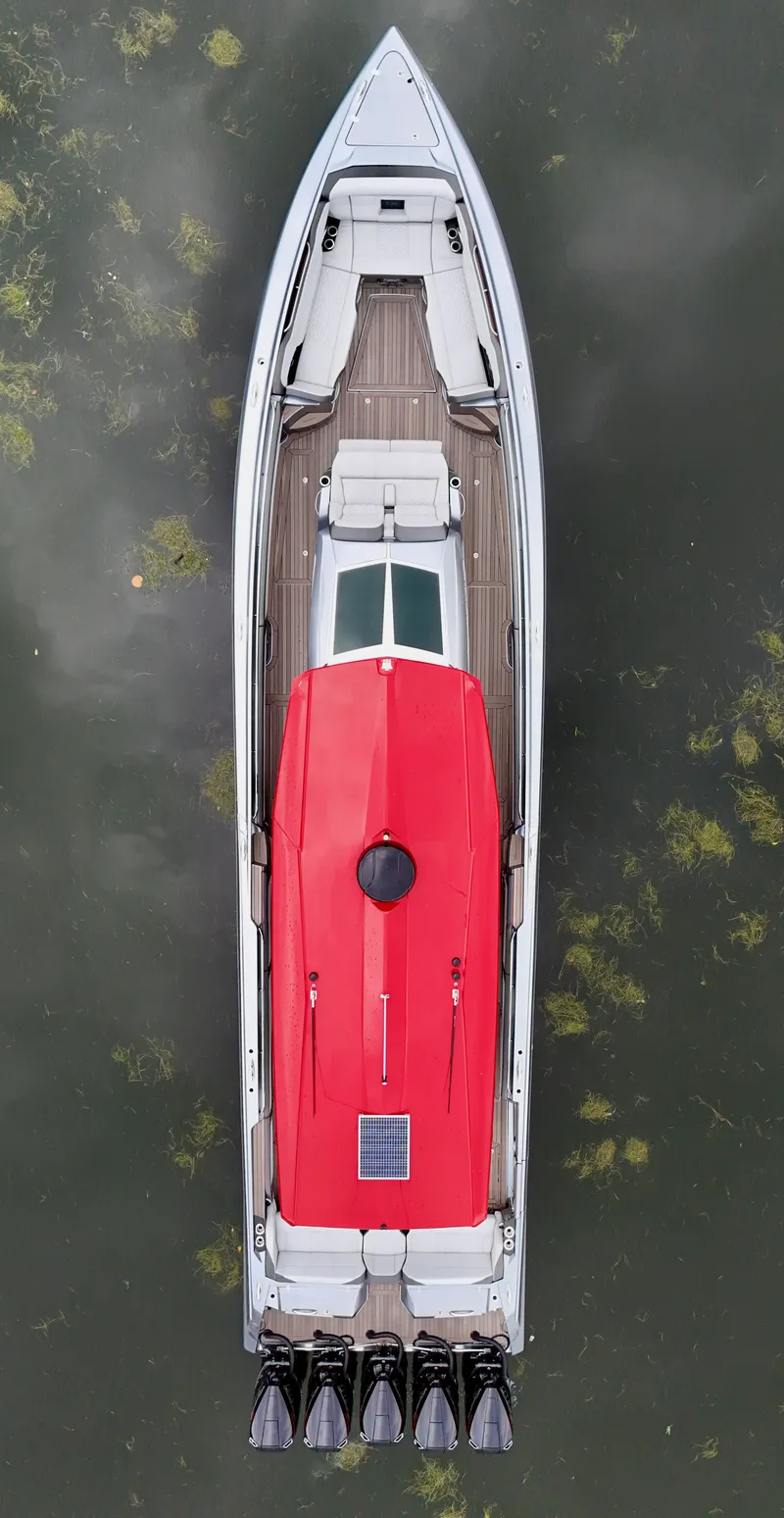 Slide: The Image of Overhead view of 2022 Nor-Tech 50 Sport boat with red cover on water. - 42