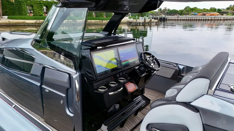 Slide: The Image of 2022 Nor-Tech 50 Sport boat cockpit with dual screens and sleek design. - 45