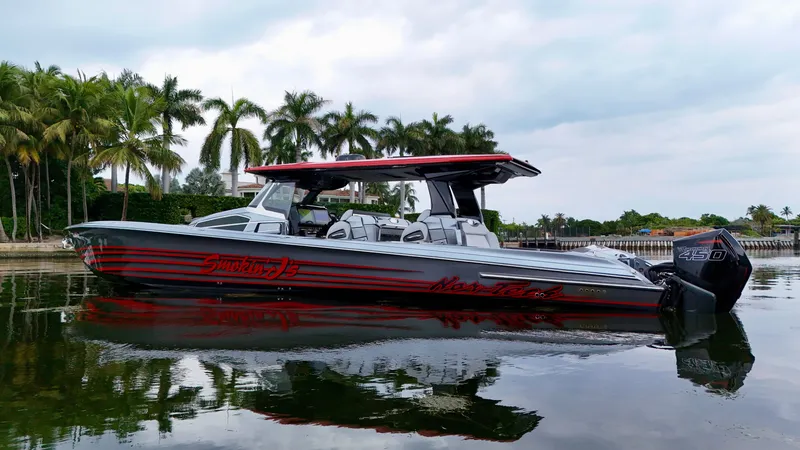 Slide: The Image of 2022 Nor-Tech 50 Sport boat on calm water, surrounded by palm trees. - 47