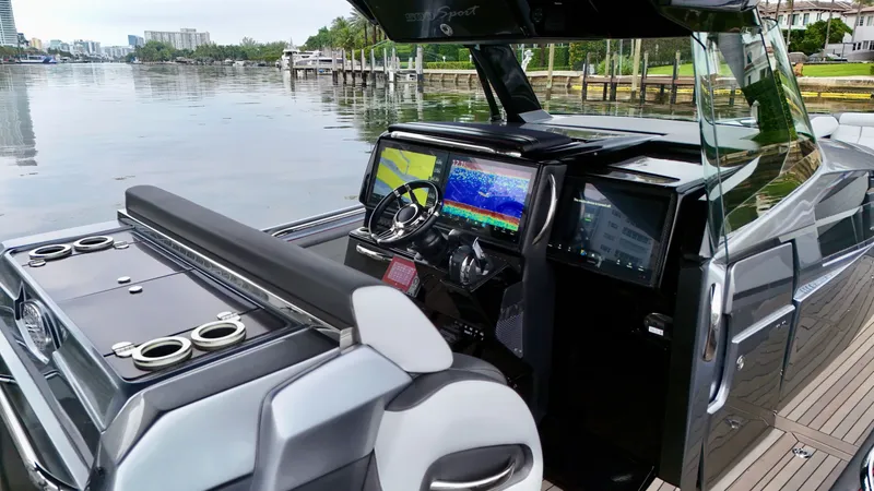 Slide: The Image of 2022 Nor-Tech 50 Sport boat cockpit with advanced navigation displays and sleek design. - 48
