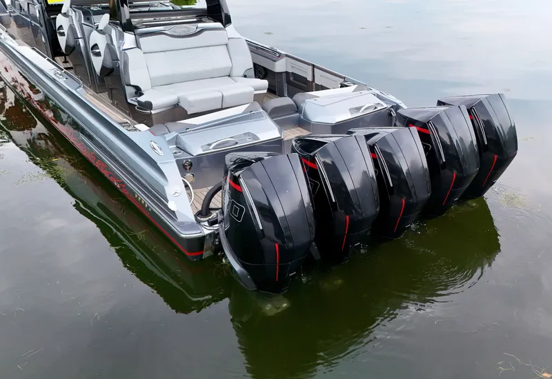 Slide: The Image of 2022 Nor-Tech 50 Sport boat with multiple powerful outboard engines on calm water. - 49