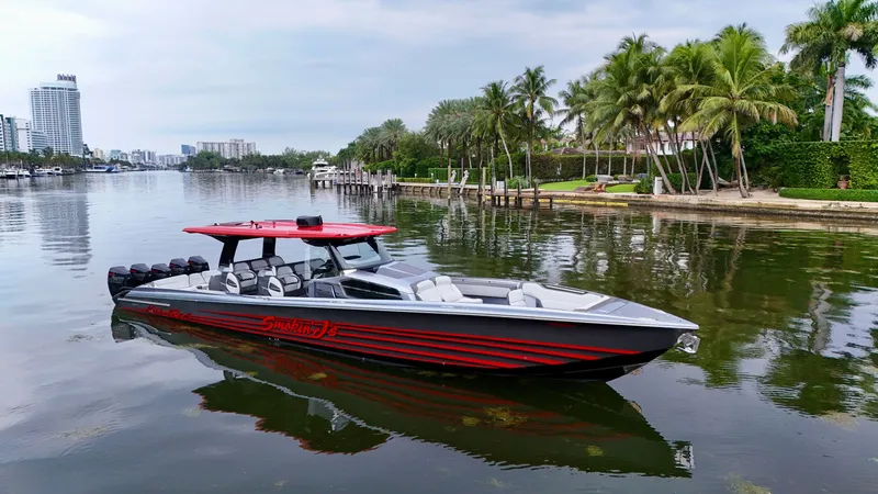 Slide: The Image of 2022 Nor-Tech 50 Sport boat on a calm waterway with palm trees and cityscape. - 5