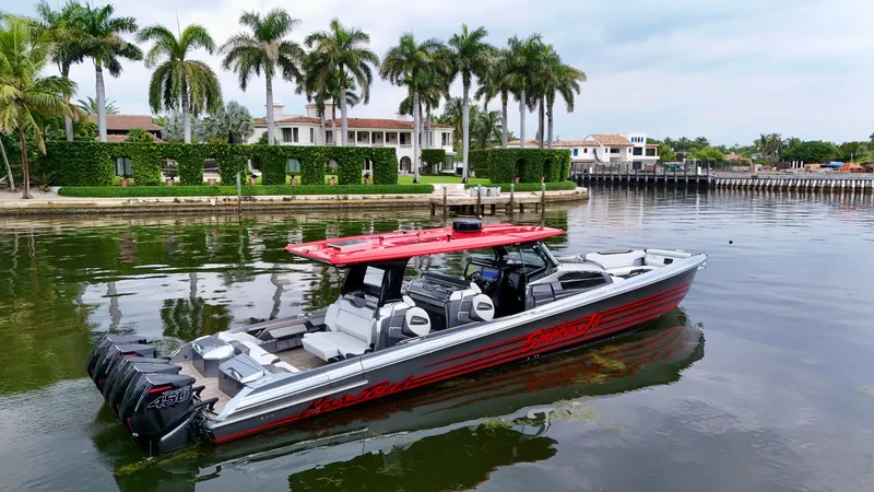 Slide: The Image of 2022 Nor-Tech 50 Sport boat on water, luxury waterfront homes, palm trees in background. - 7