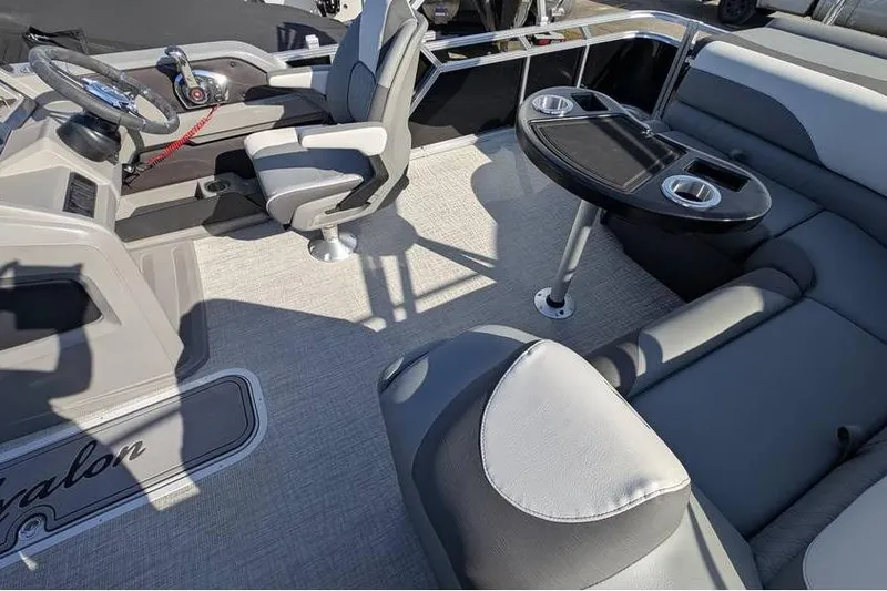 Slide: The Image of 2025 Avalon 2385 LSZ Cruise boat interior with seating and steering console. - 13