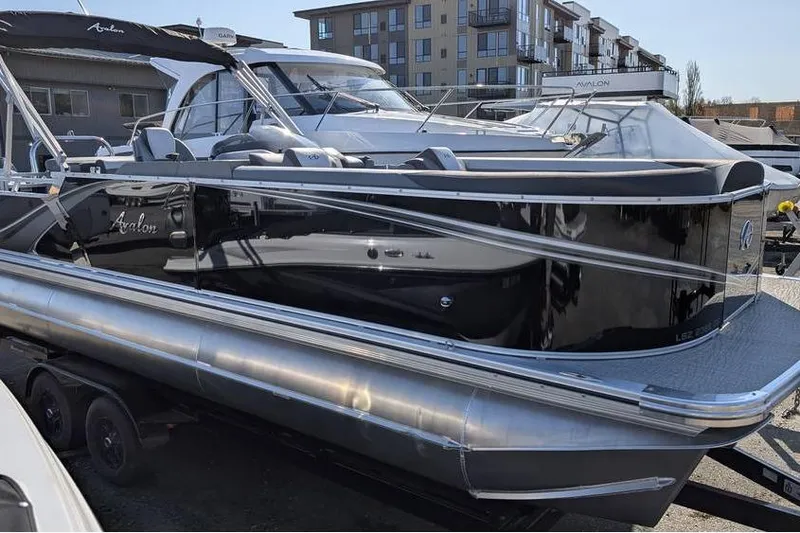 Slide: The Image of 2025 Avalon 2385 LSZ Cruise pontoon boat in marina setting. - 2
