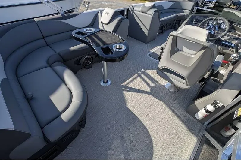 Slide: The Image of 2025 Avalon 2385 LSZ CRUISE boat interior with gray seating and modern dashboard. - 23