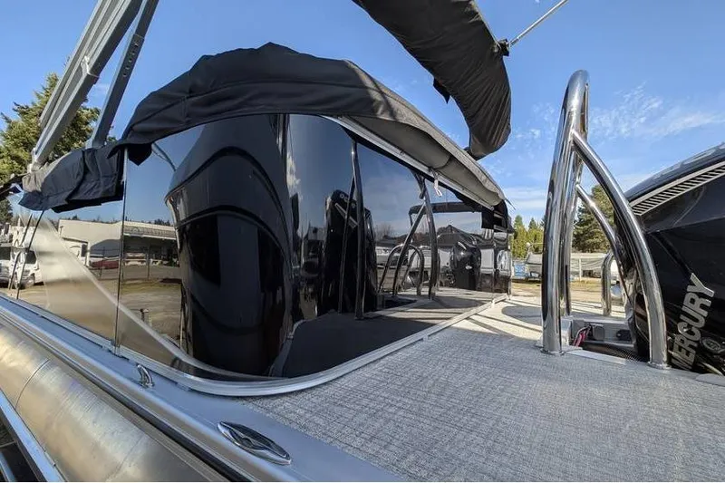 Slide: The Image of 2025 Avalon 2385 LSZ Cruise pontoon boat with sleek black exterior and modern design. - 5